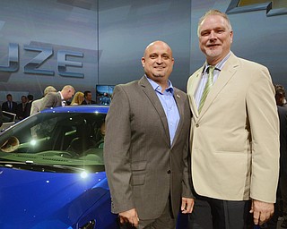 Katie Rickman | The Vindicator.UAWW 1714 President Robert Morales on left and UAW 1112 President Glenn Johnson stand next to the 2016 Cruze after its unveiling in Detroit, Michigan June 24, 2015.
