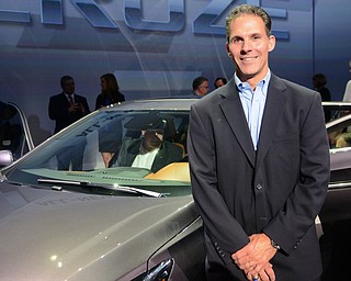 Katie Rickman | The Vindicator.Steve Notar Donato, Lordstown plant manager poses next to the 2016 Cruze after its unveiling in Detroit, Michigan June 24, 2015.