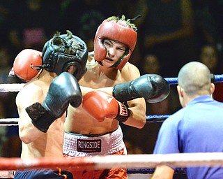 Jeff Lange | The Vindicator  JUNE 24, 2015 - Darren Jordonek of Mineral Ridge (facing) lands a punch on welterweight opponent Paul Crupi of Maplewood, Wednesday evening during the K.O. Drugs High School Boxing Championships held at Old South Range High School.