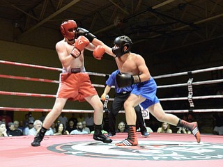 Jeff Lange | The Vindicator  JUNE 24, 2015 - Ursuline light heavyweight Anthony Morgione (right) lands a punch on Southington's Joseph Morris in first round action of Wednesday's main event during the K.O. Drugs High School Boxing Championships held in North Lima. Morgione won by unanimous decision.