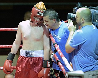 Jeff Lange | The Vindicator  JUNE 24, 2015 - Springfield's Nick Krinos (left) is congratulated by boxing coach from Burnside Boxing (center) after Krinos defeated Nicholas Petro by retirement after a minute of the first round of their junior cruiserweight championship bout, Wednesday evening in North Lima.