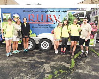 SPECIAL TO THE VINDICATOR
Youth ministries of Holy Family Church in Poland and Christ the Good Shepherd in Campbell participated in Project Grow on June 19 and 20. The event was a Diocesan-sponsored beautification and stewardship project for high school students. The youths cleared several
lots of overgrown bushes and trash and planted evergreen trees in established Pocket Parks along the lower part of South Avenue in Youngstown. The event included an overnight retreat at Villa Maria Conference and Retreat Center in Villa Maria, Pa. Above from left are Holy Family participants Maria LoCicero, Margaret Christopher, Olivia Christopher, Angelina Sabatino, Elise Cowles, Paige Brockway and Ross Fabrizi standing in front of R.U.B.Y. Youngstown’s Community Beautification Trailer. From left below are Christian Nieves of Christ
the Good Shepherd; LoCicero; Sgt. Anita Davis, Youngstown Police Department, retired; and Olivia Christopher, who worked together to beautify a Pocket Park.