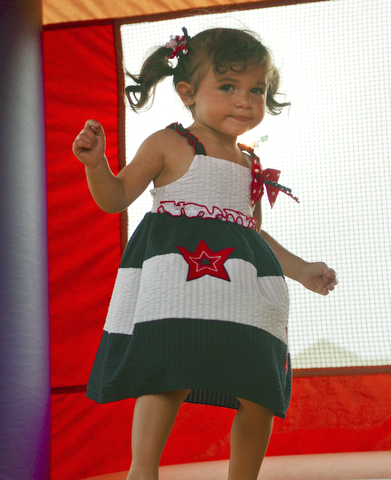 Katie Rickman | The Vindicator.Eva Lemke 1 jumps in the bounce house at the Austintown Fireworks Celebration July 3, 2015.