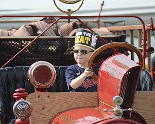Katie Rickman | The Vindicator.Marty Benedict 3 of Austintown pretends the steer the old fashioned fire truck on display at the Austintown Fireworks Celebration July 3, 2015.