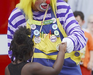 Katie Rickman | The Vindicator.Christina Eskew 4 dances with a clown while waiting in line for a face painting at the Austintown Fireworks Celebration July 3, 2015.