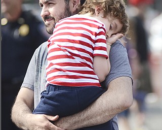 Katie Rickman | The Vindicator.Brian Necastro of Canfield holds his son Noah 4 at the Austintown Fireworks Celebration July 3, 2015.