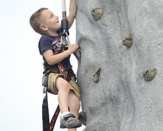 Katie Rickman | The Vindicator.Ethan Dean 4 of McDonald climbs up the rock wall at the Austintown Fireworks Celebration July 3, 2015.