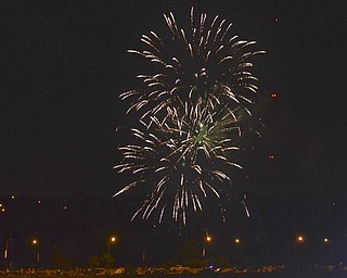 Katie Rickman | The Vindicator.Local families enjoy fireworks downtown Youngstown on July 3, 2015.  Cars lined Vindicator Sq., Front Street, the Market Street Bridge and many roads leading towards the Covelli Centre where the fireworks were set off.