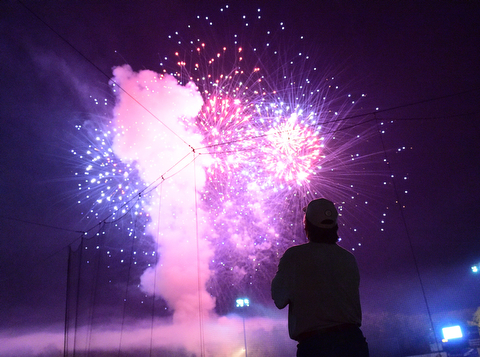 NILES, OHIO - JULY 4, 2015: Jeff Russell of Warren watches the post game fireworks display from the concourse at Eastwood Field Saturday night. DAVID DERMER | THE VINDICATOR