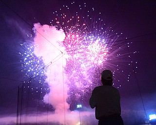 NILES, OHIO - JULY 4, 2015: Jeff Russell of Warren watches the post game fireworks display from the concourse at Eastwood Field Saturday night. DAVID DERMER | THE VINDICATOR