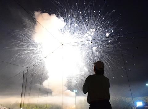 NILES, OHIO - JULY 4, 2015: Jeff Russell of Warren watches the post game fireworks display from the concourse at Eastwood Field Saturday night. DAVID DERMER | THE VINDICATOR