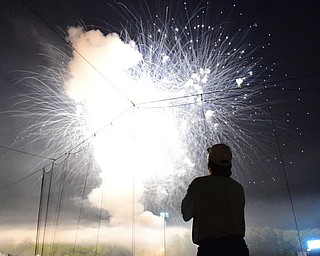 NILES, OHIO - JULY 4, 2015: Jeff Russell of Warren watches the post game fireworks display from the concourse at Eastwood Field Saturday night. DAVID DERMER | THE VINDICATOR