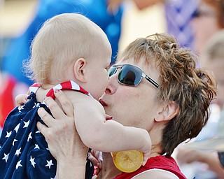 Jeff Lange | The Vindicator  JULY 4, 2015 - Rose Kusky of Canfield plants a kiss on her one-year-old granddaughter Genevieve along the route of the 2015 Fourth of July Parade in Canfield, Saturday morning.