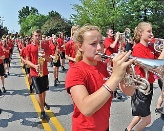 Jeff Lange | The Vindicator  JULY 4, 2015 - Mellophone player in the Canfield marching band, Olivia VanDevender (front) is joined by fellow horn player Brooke Broker (far right) and other band members as the band performs patriotic tunes for the citizens of Canfield during the parade, Saturday morning.