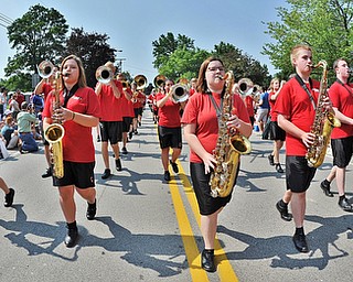 Jeff Lange | The Vindicator  JULY 4, 2015 - (From left) Tenor saxophone players Shannon Rishar, Kelsey Eckert, Rachel Sinclair, Brandon Stratton and Jack Cross march down the street with the band during Saturday morning's 4th of July parade in Canfield.