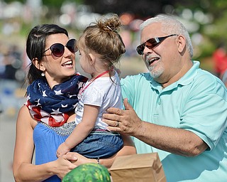 Jeff Lange | The Vindicator  JULY 4, 2015 - Erica Vass of Boardman (left) and Ron Vass (right) of Canfield embrace two-year-old Delaney Vass during Saturday's 4th of July festivities in Canfield.