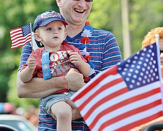 Jeff Lange | The Vindicator  JULY 4, 2015 - 2 year old Braden James tags along with his grandfather Steve Kirr as he chaperones the children's decorated bicycles in Saturday's 4th of July parade in Canfield. Braden is the son of Amy and Mike James of Canfield.