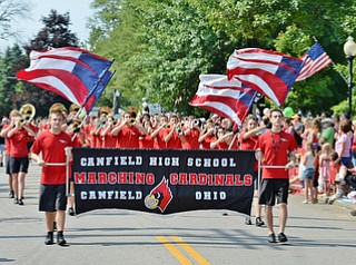 Jeff Lange | The Vindicator  JULY 4, 2015 - The Canfield High School Marching Cardinals perform patriotic tunes as they participate in the 2015 Fourth of July parade at the square in Canfield, Saturday morning.