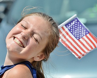 Jeff Lange | The Vindicator  JULY 4, 2015 - Beaming with joy and patriotism, 11 year old Maya Hoffman of Salem is shown enjoying the spirit and festivities of Saturday's July 4th celebration in Canfield.