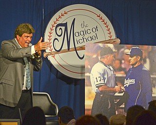 Katie Rickman | The Vindicator.Ed Muransky motions with his hand while auctioning off a large print of a photo with John Hirschbeck and Joe Torre confronting one another during a game years ago. The photo was one of the many pieces auctioned off at the The Magic of Michael benefit dinner at the Lake Club in Poland Sunday July 5, 2015.