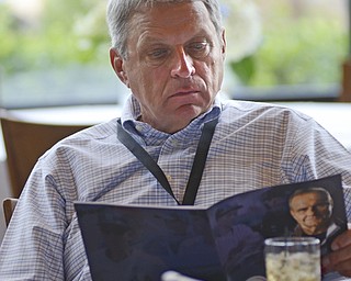 Katie Rickman | The Vindicator.Dick Hockin of Indiana, Pennsylvania reads a program at meet and greet where attendees were able to meet Joe Torre prior to The Magic of Michael benefit dinner at the Lake Club in Poland on July 5, 2015.