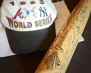 Katie Rickman | The Vindicator.A baseball hat and bat belonging to Dan Turner of Poland sits on a table at the meet and greet with Joe Torre prior to The Magic of Michael benefit dinner at the Lake Club in Poland on July 5, 2015.