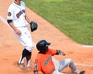 NILES, OHIO - JULY 5, 2015: Cedric Mullins #6 of the Ironbirds slides across home plate to score a run after a wild pitch from Kieran Lovegrove #38 of the Scrappers in the 1st inning during Sunday afternoons game at Eastwood Field. DAVID DERMER | THE VINDICATOR
