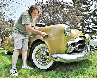Jeff Lange | The Vindicator  JULY 5, 2015 - Allen Fredrickson of Garrettsville shines his 1951 200 Deluxe Packard before hundreds of "All Makes Cruise In" visitors walk by to admire his classic car, Sunday afternoon at the National Packard Museum in Warren.