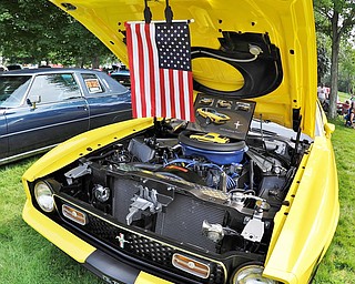 Jeff Lange | The Vindicator  JULY 5, 2015 - A yellow Mustang Mach 1 proudly displays an American flag from the underside of it's hood during Sunday's car show in Warren.