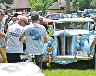 Jeff Lange | The Vindicator  JULY 5, 2015 - A team of about a half dozen men pull a 1937 Packard V-12 Coupe Roadster out of the mud during Sunday's car show at the National Packard Museum in Warren. The 1937 Packard is owned by Mike Kochilla of North Royalton.