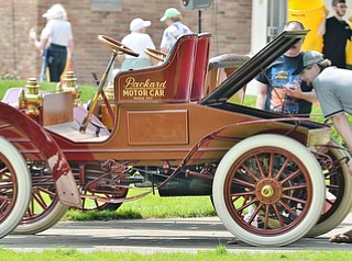 Jeff Lange | The Vindicator  JULY 5, 2015 - Scott Lydic of Kane, PA bends down to view the engine of a 1901 Packard Model F during Sunday's car show in Warren.