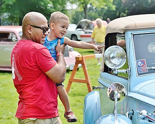 Jeff Lange | The Vindicator  JULY 5, 2015 - Three-year-old Cameron Colbert of Warren points at a 1937 Packard V-12 Coupe Roadster in excitement as his father Eddie Colbert looks on during Sunday's car show in Warren.
