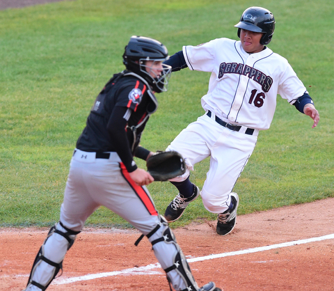 NILES, OHIO - JULY 6, 2015: Base runner Li-Jen Chu #16 of the Scrappers slides into home plate to score a run before catcher Jerry McClanahan #9 of the Ironbirds can receive the baseball  in the 2nd inning of Monday nights game at Eastwood Field. DAVID DERMER | THE VINDICATOR
