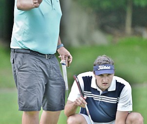Jeff Lange | The Vindicator  JULY 6, 2015 - Owner of the Lake Club in Poland, Ed Muransky (left) gives putting tips to his son Eddie during Monday's Magic of Michael Foundation golf outing at the Lake Club.