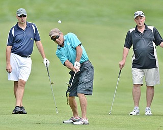 Jeff Lange | The Vindicator  JULY 6, 2015 - Rick Jones of New Springfield makes an iron shot onto the green as teammates Travis Hughes of Medina (left) and Brian Girts of Poland look on from behind during the Magic of Michael Foundation golf outing held at the Lake Club in Poland, Monday.