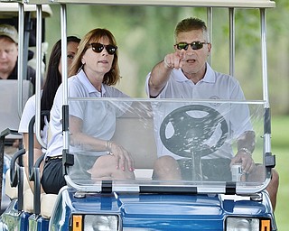 Jeff Lange | The Vindicator  JULY 6, 2015 - Major League Baseball umpire John Hirschbeck (right) points onward to the next hole as his wife Denise looks on from the passenger's seat of the golf cart during the Magic of Michael Foundation golf outing held at the Lake Club in Poland on Monday.