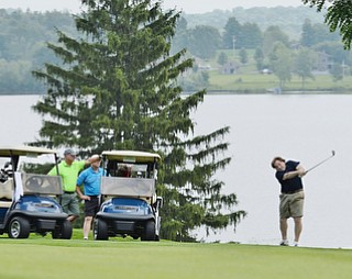 Jeff Lange | The Vindicator  JULY 6, 2015 - Ed Macabobby (right) of Poland watches his shot from the fairway as his teammates Ken McMahon of Poland, Kevin O'Leary of Youngstown and Jeff Davis of Poland look on from the carts during Monday's Magic of Michael Foundation golf outing held at the Lake Club in Poland, Monday afternoon.