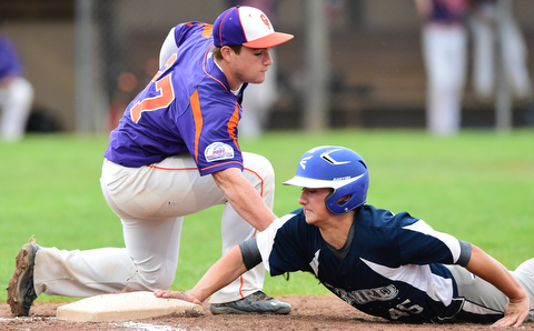 STRUTHERS, OHIO - JULY 8, 2015: Danny Williams #45 of Baird Brothers gets his hand on the bag to avoid being picked off by first basemen Pad O'Shaughnessy #27 of Creekside in the 2nd inning during Wednesday nights Little B championship game at Cene Park.