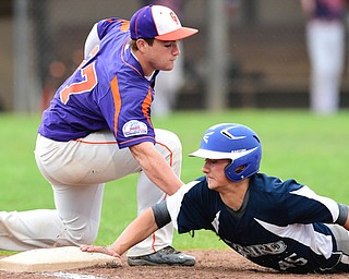 STRUTHERS, OHIO - JULY 8, 2015: Danny Williams #45 of Baird Brothers gets his hand on the bag to avoid being picked off by first basemen Pad O'Shaughnessy #27 of Creekside in the 2nd inning during Wednesday nights Little B championship game at Cene Park.