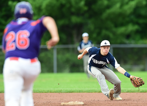 STRUTHERS, OHIO - JULY 8, 2015: Short stop Vinnie Monico #2 of Baird Brothers reaches out to field the baseball before forcing out Dom Pecchia #26 of Creekside in the 3rd inning during Wednesday nights Little B championship game at Cene Park.