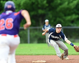 STRUTHERS, OHIO - JULY 8, 2015: Short stop Vinnie Monico #2 of Baird Brothers reaches out to field the baseball before forcing out Dom Pecchia #26 of Creekside in the 3rd inning during Wednesday nights Little B championship game at Cene Park.