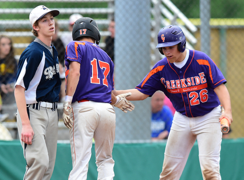 STRUTHERS, OHIO - JULY 8, 2015: Don Drummond #17 is congratulated by Dom Pecchia #26 of Creekside after scoring a run off of pitcher Colin Ruth #1 of Baird Brothers in the 4th inning during Wednesday nights Little B championship game at Cene Park.
