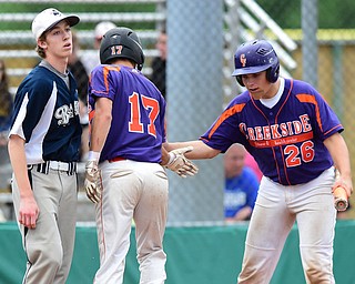 STRUTHERS, OHIO - JULY 8, 2015: Don Drummond #17 is congratulated by Dom Pecchia #26 of Creekside after scoring a run off of pitcher Colin Ruth #1 of Baird Brothers in the 4th inning during Wednesday nights Little B championship game at Cene Park.