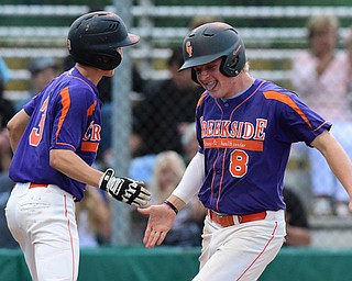 STRUTHERS, OHIO - JULY 8, 2015: Bryce Richey #8 is congratulated by teammate Noah Suaeez #3 after scoring a run in the 6th inning during Wednesday nights Little B championship game at Cene Park.