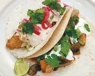 One consistent feature of the menu at The Kitchen Post is a variety of soft tacos, including Cajun Mushroom and Potato (bottom taco) and Fish (top taco). 