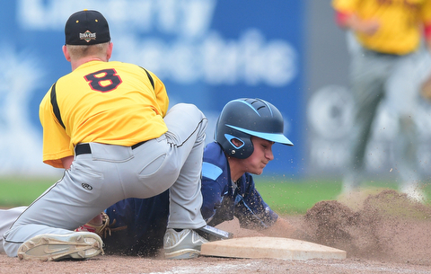 STRUTHERS, OHIO - JULY 10, 2015: Base runner Josh Frisk #8 of Roth dives into first base to avoid being picked off by pitcher Dan Boerio #8 of DuraEdge in the 3rd inning during Friday nights Class B baseball game at Cene Park. DAVID DERMER | THE VINDICATOR