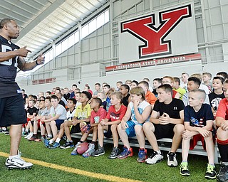 Jeff Lange | The Vindicator  JULY 11, 2015 - Former linebacker in the NFL Tim Johnson (left) speaks to children during his annual football camp at the WATTS center in Youngstown Saturday morning.