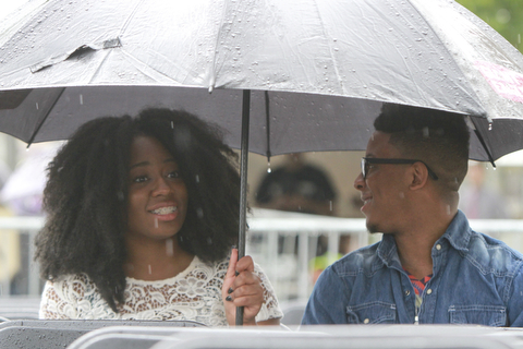 William DLewis The Vindicator  Rain didn't dampen the spirits of Destiny Hughes and Cordell Jackson,bothof Youngstown as they waited for start of 2015Gospel Festival in downtown Youngstown Sunday 7-12-15.