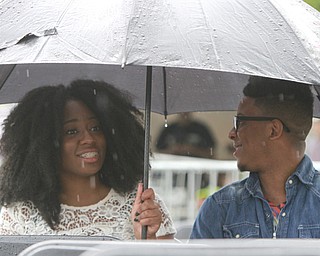 William DLewis The Vindicator  Rain didn't dampen the spirits of Destiny Hughes and Cordell Jackson,bothof Youngstown as they waited for start of 2015Gospel Festival in downtown Youngstown Sunday 7-12-15.
