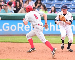 NILES, OHIO - JULY 17, 2015: Third basemen Nate Winfrey #17 of the Scrappers charges in on the baseball while base runner Andrew Stevenson #3 of the Doubledays runs in front of him in the 3rd inning during Friday nights game at Eastwood Field. DAVID DERMER | THE VINDICATOR.